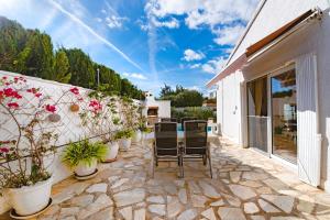 a patio with chairs and potted plants at Sunbathing with private swimming pool in Calpe