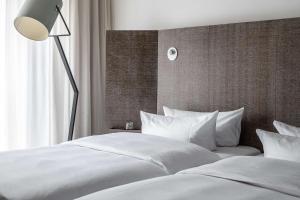 Postel nebo postele na pokoji v ubytování pentahotel Braunschweig