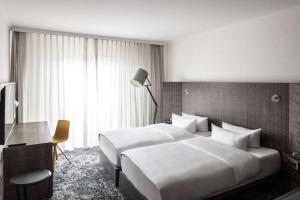 Postel nebo postele na pokoji v ubytování pentahotel Braunschweig