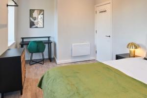 a bedroom with a bed and a desk and a chair at Host & Stay - Mariposa Waterloo in Sefton +6 photos