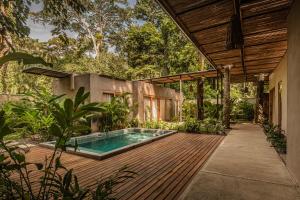 a house with a swimming pool on a wooden deck at La Bonita Lodge in Puerto Viejo