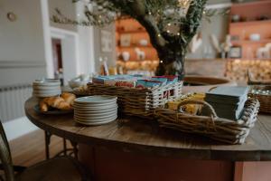 a table with baskets and plates and bread on it at The Murray Arms - Award Winning Boutique Hotel in Gatehouse of Fleet