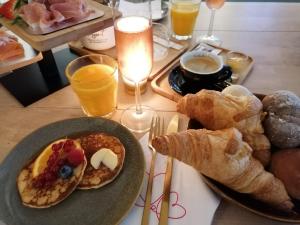a table with a plate of breakfast foods and drinks at Entre 2 Mers - Charming guesthouse in Cancon