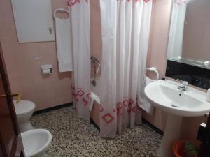a bathroom with a toilet and a sink and a shower at Casa Adelina in Morella +17 photos