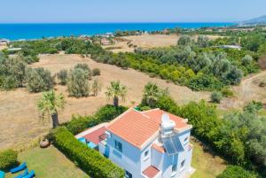 an aerial view of a house with the ocean in the background at Villa Aristotelis in Argaka