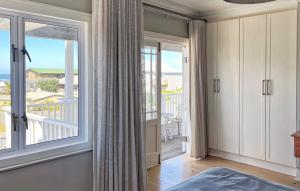 a bedroom with a large window with a view of the ocean at SandDollar - Entire house in Cape St Francis +68 photos