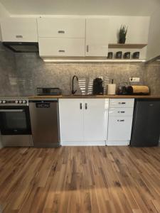 Kuchyň nebo kuchyňský kout v ubytování Apartament Hey Gron