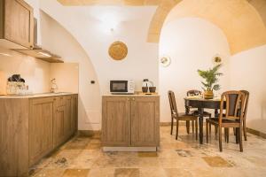 a kitchen and dining room with a table and chairs at Sassi Suite - Elegant Historic Home in Matera +30 photos