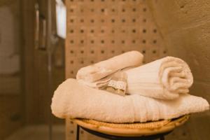 a bathroom with a towel and a roll of towels at Sassi Suite - Elegant Historic Home in Matera