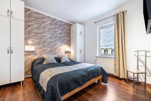 a bedroom with a bed and a wooden floor at Ferienwohnung Krause Dachgeschoss in Wilhelmshaven