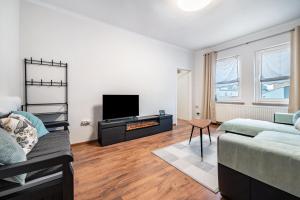 a living room with a bed and a tv at Ferienwohnung Krause Dachgeschoss in Wilhelmshaven