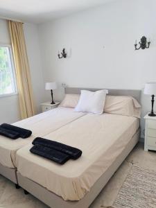 a bedroom with a large bed with two towels on it at Sunbathing with private swimming pool in Calpe +7 photos