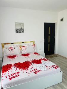 a bedroom with a bed covered in red roses at Vila Sephora in Eforie Nord