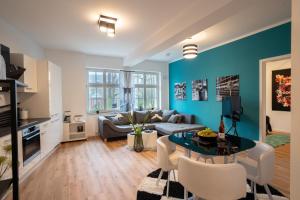a living room with a couch and a table at ANER 4 Design Apartment Zoe in Dresden