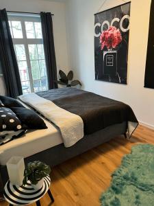 a bedroom with a large bed with a vase of flowers at ANER 4 Design Apartment Zoe in Dresden
