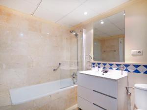 a bathroom with a tub and a sink and a shower at Banana Beach in Marbella