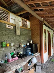a kitchen with a counter with pots and pans at Ayolah surf House and Surfcamp in Jembrana