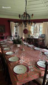 a long table with plates and wine glasses on it at Casa do Barreiro de Cima in Mondim de Basto +10 photos