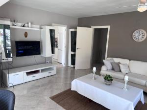 a living room with a couch and a tv at Sunbathing with private swimming pool in Calpe
