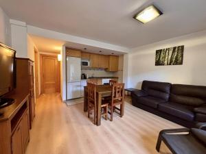 a living room with a couch and a table at BPirineos-Casa Chuanina in Benasque