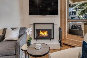 a living room with a couch and a fireplace at New Listing 2BR 2BA Condo - Mountain Views in Aspen