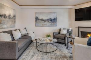 a living room with a couch and a fireplace at New Listing 2BR 2BA Condo - Mountain Views in Aspen +48 photos