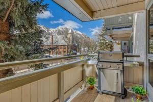 a balcony with an outdoor kitchen with a view at New Listing 2BR 2BA Condo - Mountain Views in Aspen