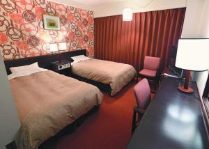 Postel nebo postele na pokoji v ubytování Bandai Silver Hotel