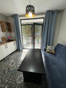 Una sala de estar con un sofá azul y una mesa. en Летняя сказка, en Cholpon-Ata 5 fotos más