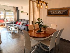a living room with a table and a couch at Apartament Marina in Tossa de Mar