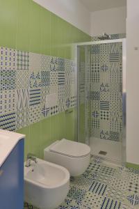 a bathroom with a toilet and a sink at L' Orologio del Campanile with terrace in Minori +19 photos
