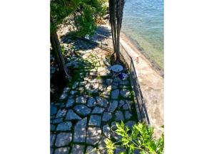 a rock pathway next to the beach with the water at Pied dans l’Eau in Brezzo