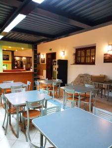 a restaurant with tables and chairs and a kitchen at Trasimeno Nature house in Castiglione del Lago