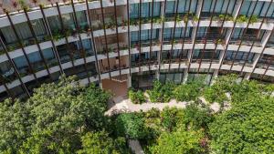 an office building with trees in front of it at Loft Hermosa at Tulum's Mistiq Temple II Beaches in Tulum