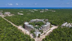 an aerial view of a building with trees and the ocean at Loft Hermosa at Tulum's Mistiq Temple II Beaches in Tulum