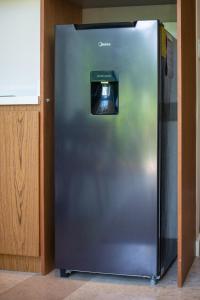a stainless steel refrigerator with a television on it at Loft Hermosa at Tulum's Mistiq Temple II Beaches in Tulum