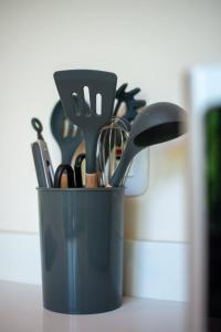 a container of kitchen utensils sitting on a counter at Loft Hermosa at Tulum's Mistiq Temple II Beaches in Tulum