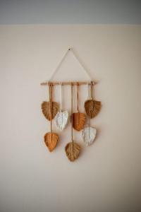 a rack with different types of shells hanging on a wall at Loft Hermosa at Tulum's Mistiq Temple II Beaches in Tulum