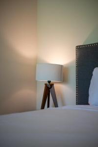 a lamp sitting next to a bed in a bedroom at Loft Hermosa at Tulum's Mistiq Temple II Beaches in Tulum