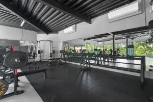 a gym with many equipment in a room at Loft Hermosa at Tulum's Mistiq Temple II Beaches in Tulum