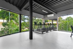 an empty room with chairs and large windows at Loft Hermosa at Tulum's Mistiq Temple II Beaches in Tulum