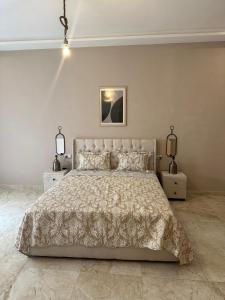 a bedroom with a large bed and two night stands at Rachos in Oujda +28 photos
