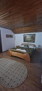 a bedroom with two beds and a wooden ceiling at Cabana Sebes Bera in Făgăraş