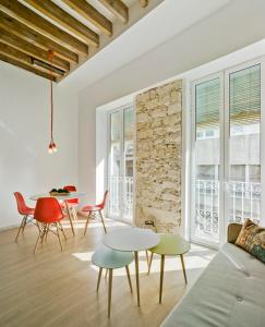 a living room with a couch and tables and chairs at MyFlats Luxury City Center in Alicante