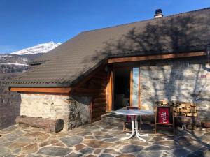 a stone building with a table in front of it at Bellissimo Chalet con vista in Faido