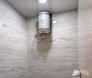 a camera on the wall of a bathroom at Krishna kunj homestay in Ujjain