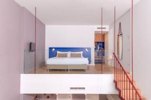 a bedroom with a bed and a glass wall at Hotel Piazza Bellini & Apartments in Naples
