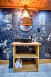 a bathroom with a sink and a mirror at Apartament Hanka z Jacuzzi i widokiem na góry in Zakopane