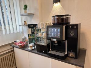 a coffee machine on a counter in a room at KEMPE Komfort Hotel in Düsseldorf