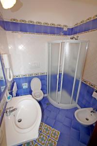 a bathroom with a shower and a toilet and a sink at Hotel La Certosa in Massa Lubrense